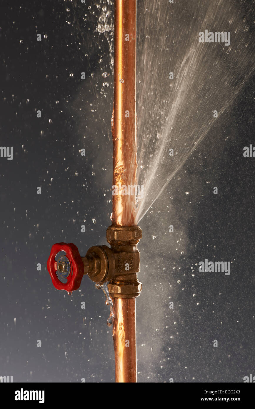 Plumbing burst Leaking Pipe with Tap Stock Photo