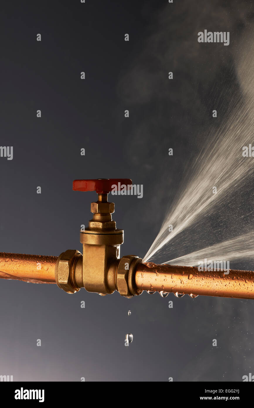 Plumbing burst Leaking Pipe with Tap Stock Photo