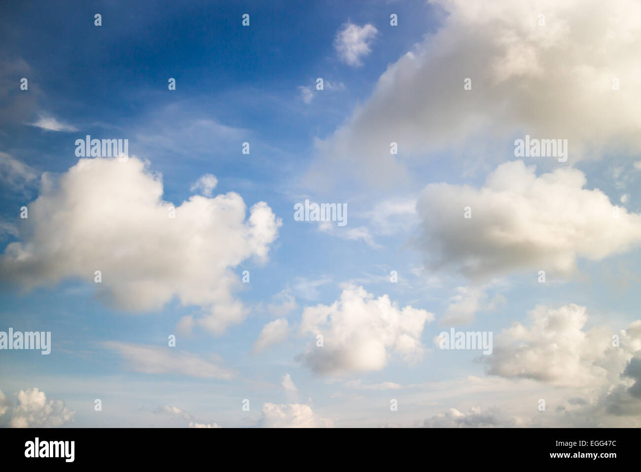 fluffy clouds in blue sky Stock Photo - Alamy