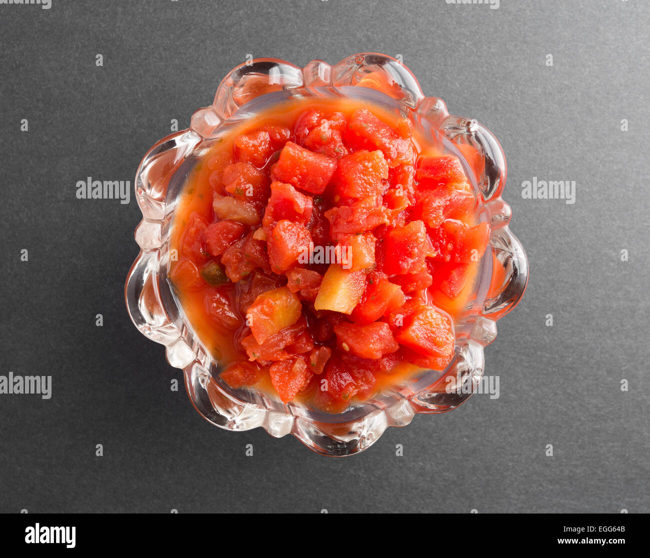 Top view of diced tomatoes in tomato juice with jalapeño peppers added