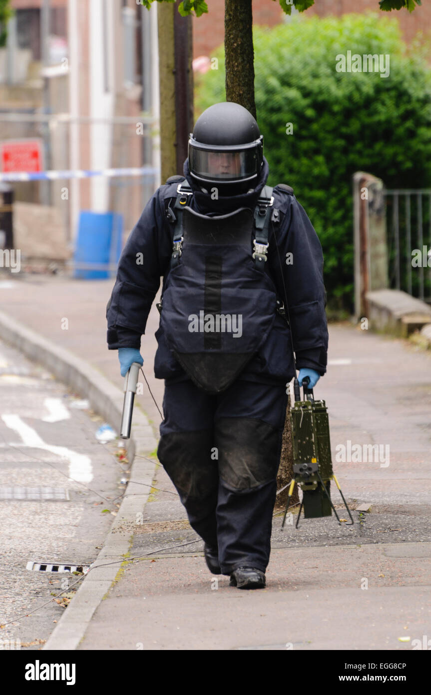 Belfast 02/07/2012 Belfast - Bomb disposal ATO walking back from a suspicious device.  He is carrying a 'pig stick', used to defuse the device without destroying evidence, and an Electronic Counter Measure (ECM) to jam electronic signals which may trigger a device. Stock Photo