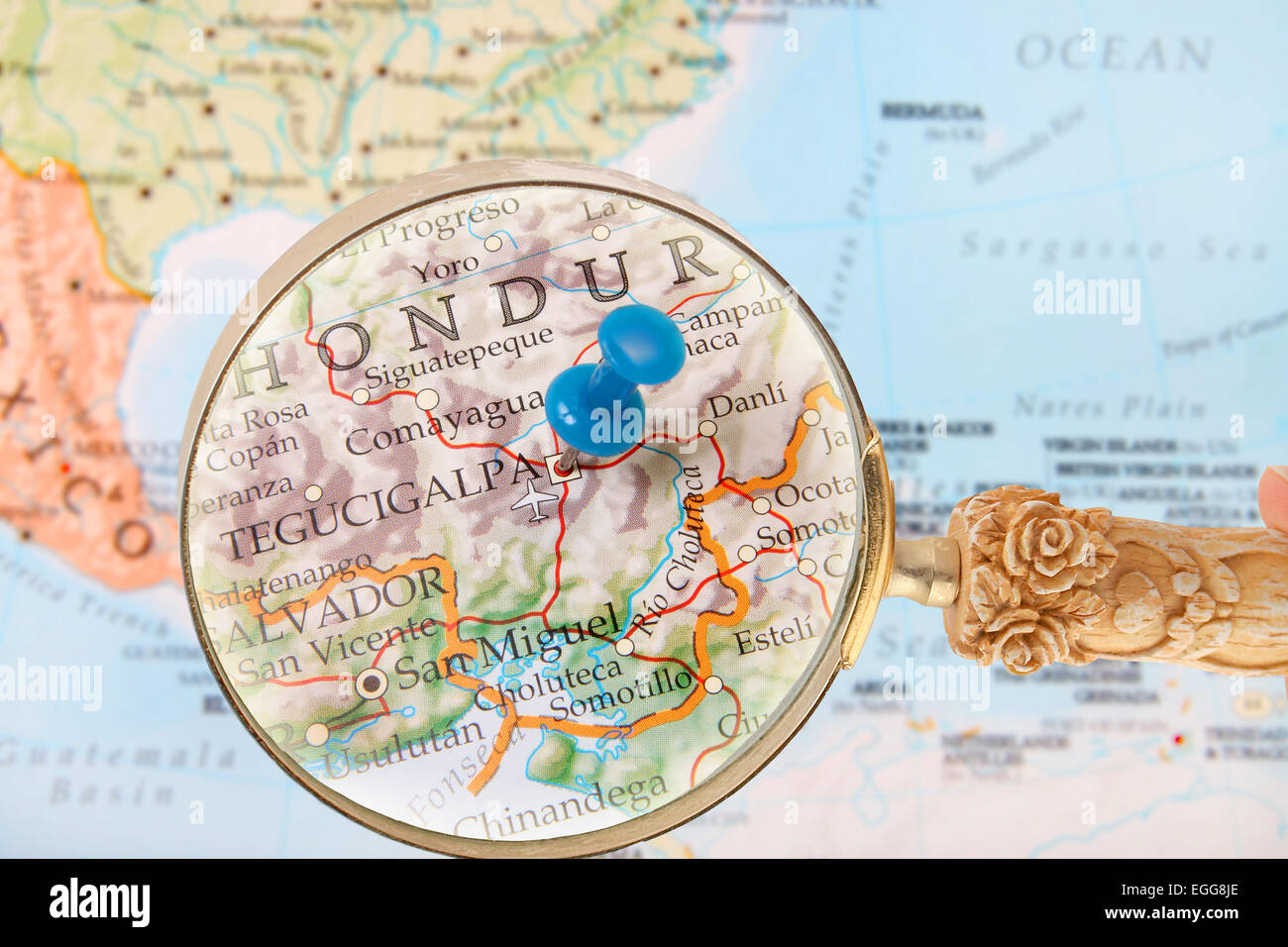 Blue tack on map of Central America with magnifying glass looking in on