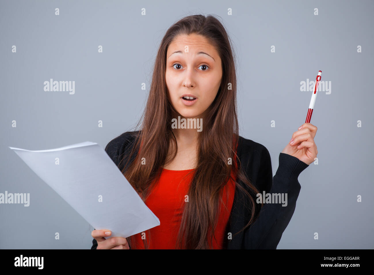 Girl with paper and pen Stock Photo - Alamy