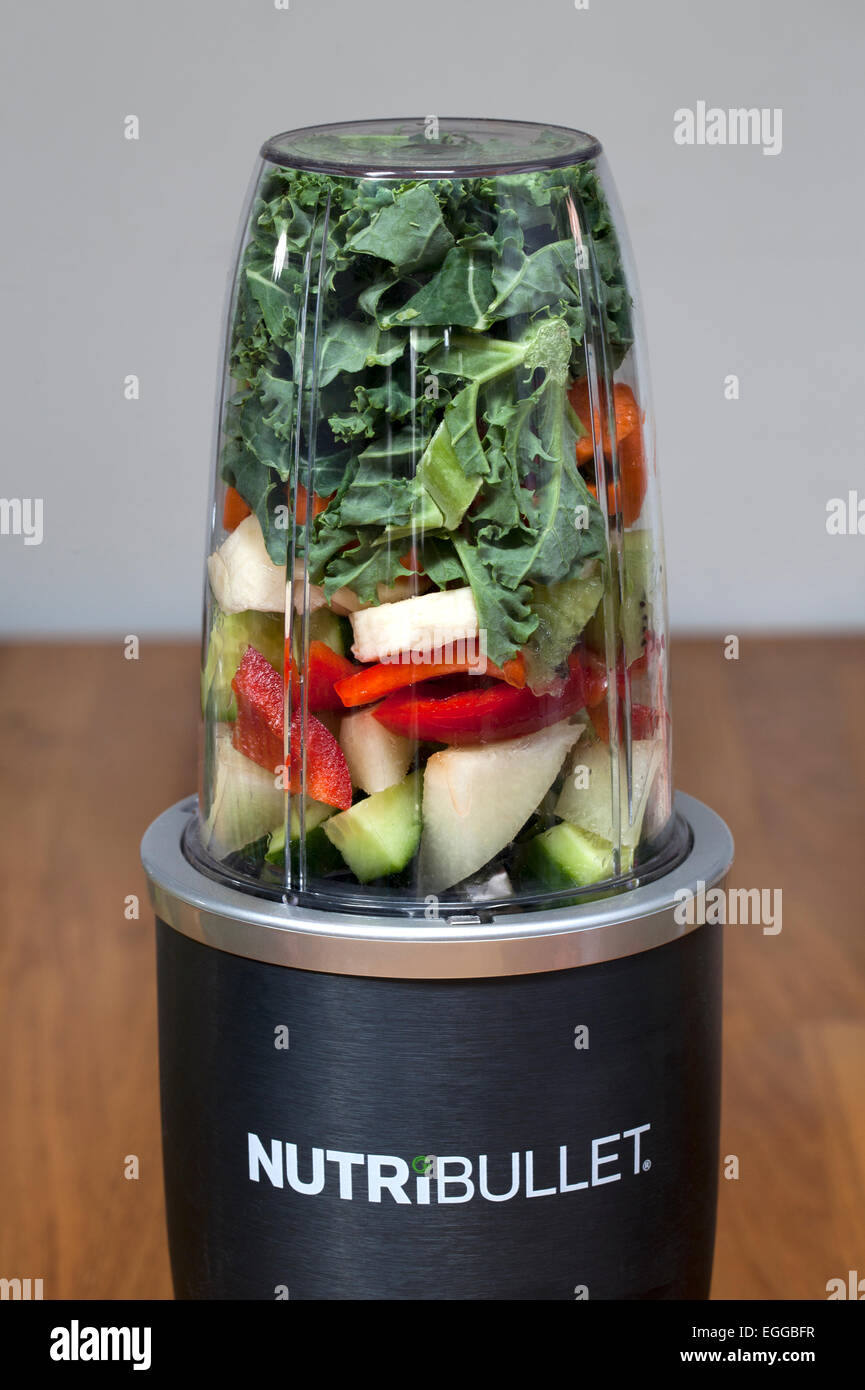 https://c8.alamy.com/comp/EGGBFR/nutribullet-food-extractor-with-raw-fruit-and-vegetable-ready-for-EGGBFR.jpg