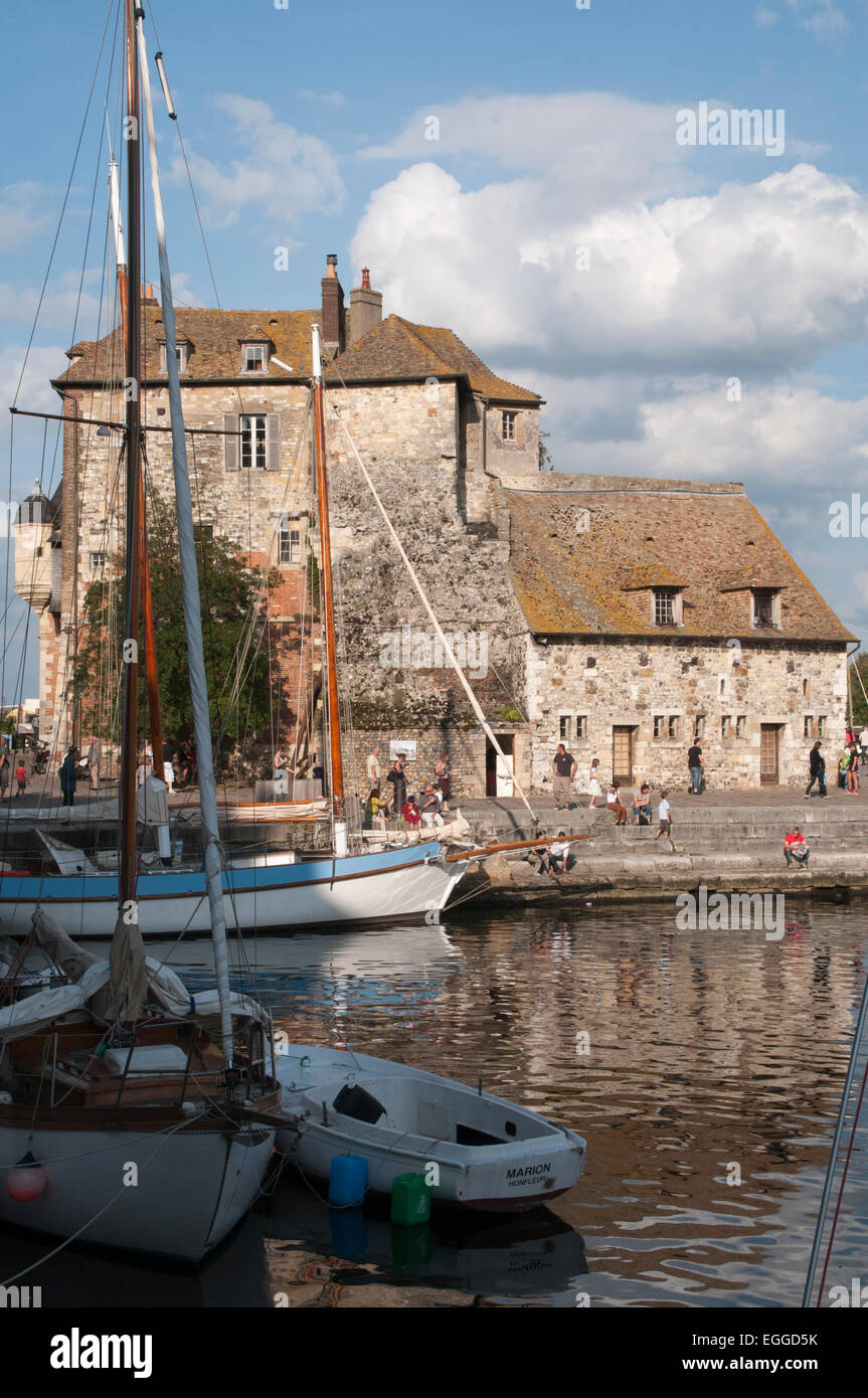 At the southern banks of the estuary of the Seine the old harbor Honfleur nowadays is a picturesque town attracting tourists. Stock Photo