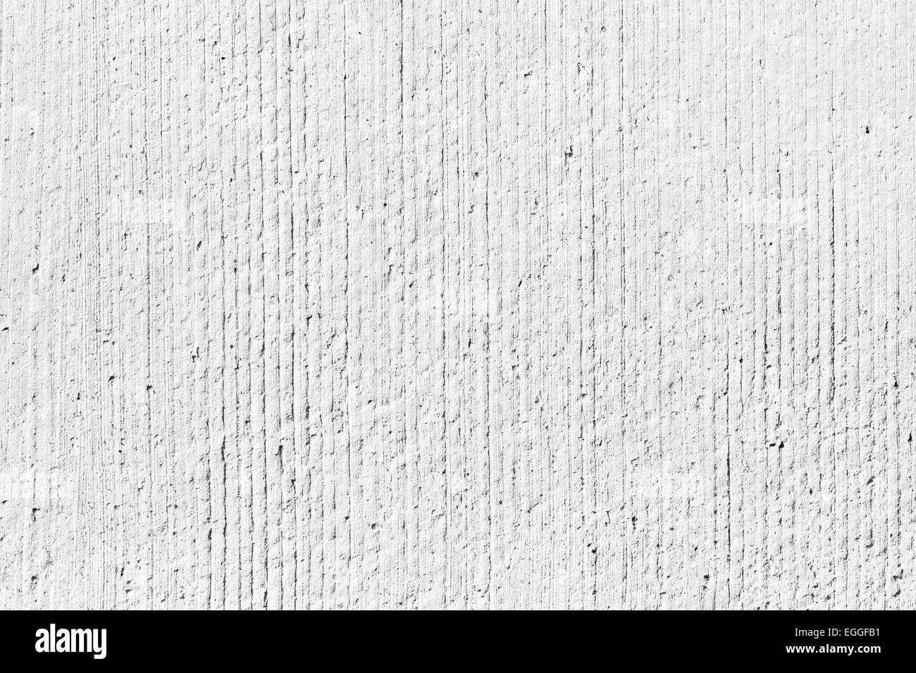 Rough white concrete wall background texture with vertical relief lines