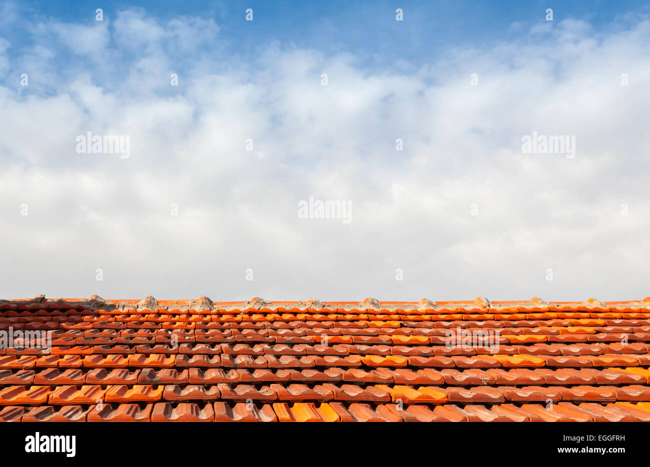 Empty photo background with red tile roof and cloudy sky Stock Photo