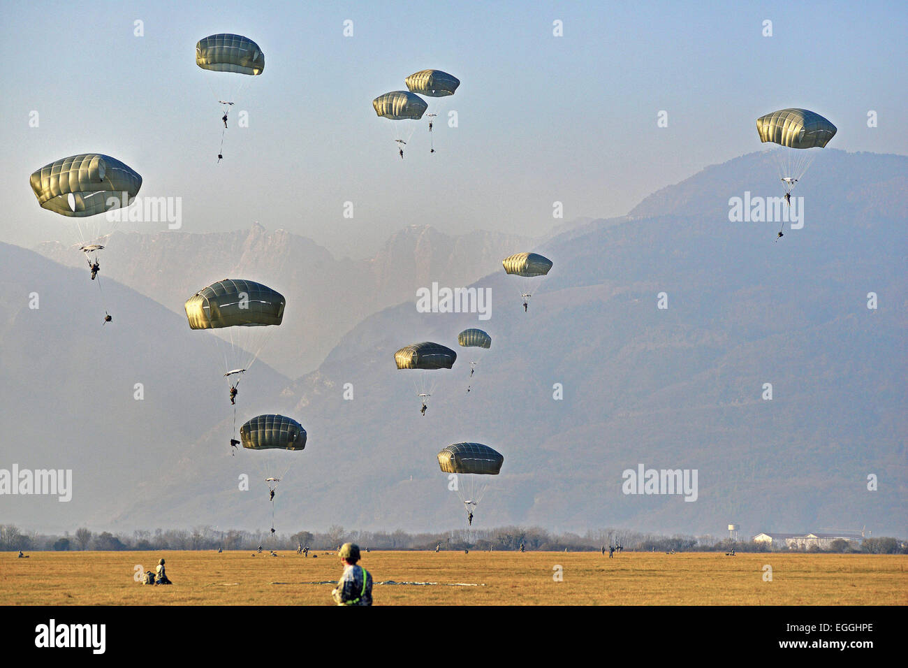 US Army paratroopers with the 173rd Airborne Brigade parachute jump during an airborne training operation February 19, 2015 in Pordenone, Italy. Stock Photo