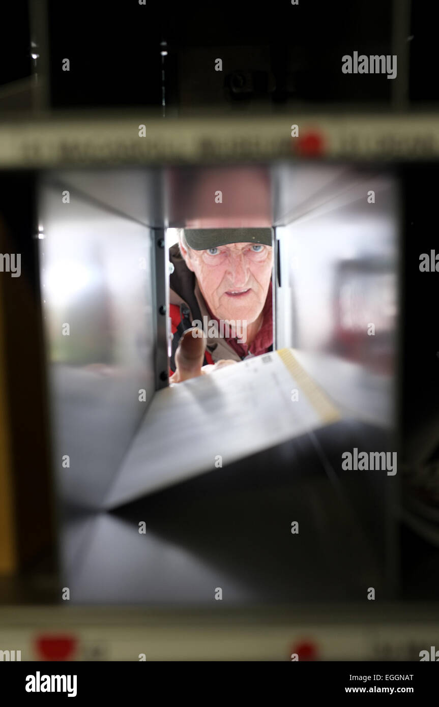 Local resident John Christie retrieves his mail from the post office in