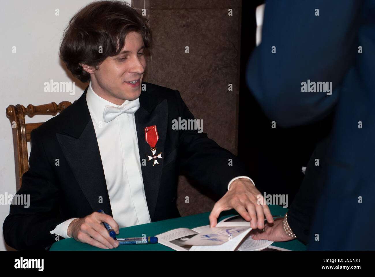 Warsaw, Poland. 24th February, 2015. Polish pianist Rafał Blechacz takes autographs after his concert in Warsaw Philharmonic when he was honoured by Knight's Cross Order of Polonia Restituta Credit:  Jakub Siemiaczko/Alamy Live News Stock Photo