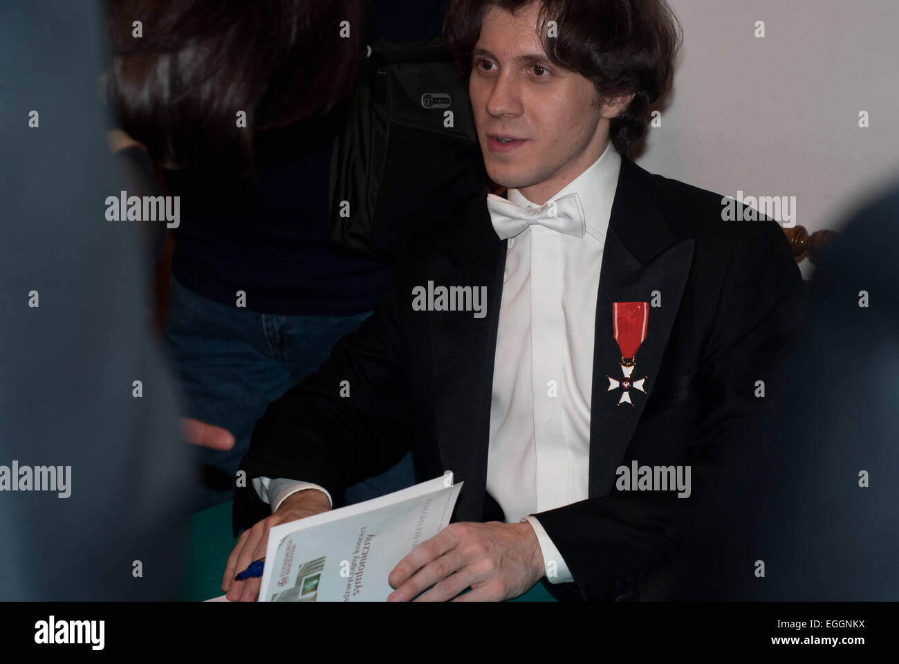 Warsaw, Poland. 24th February, 2015. Polish pianist Rafał Blechacz takes autographs after his concert in Warsaw Philharmonic when he was honoured by Knight's Cross Order of Polonia Restituta Credit:  Jakub Siemiaczko/Alamy Live News Stock Photo
