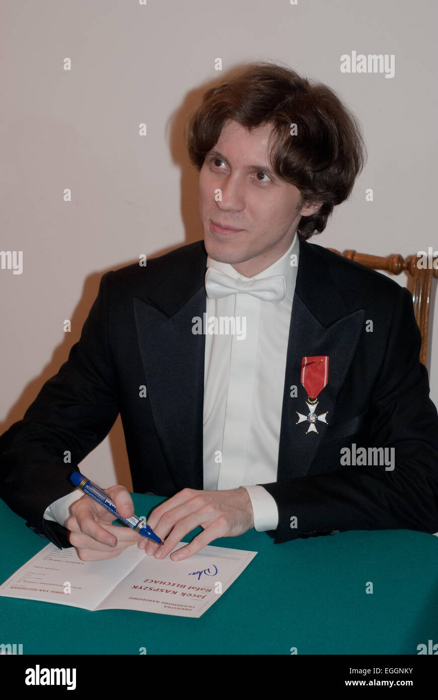 Warsaw, Poland. 24th February, 2015. Polish pianist Rafał Blechacz, winner of 2005 International Chopin Competition, takes autographs after his concert in Warsaw Philharmonic when he was honoured by Knight's Cross Order of Polonia Restituta Credit:  Jakub Siemiaczko/Alamy Live News Stock Photo