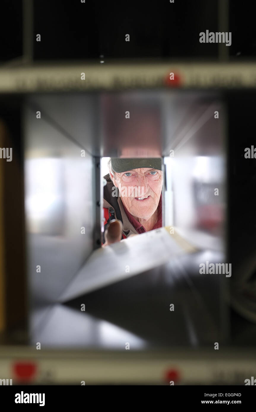 Local resident John Christie retrieves his mail from the post office in