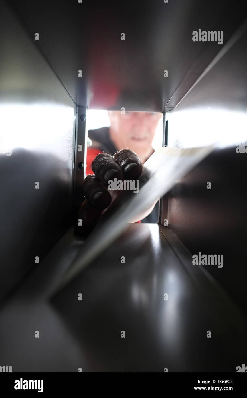 Local resident John Christie retrieves his mail from the post office in