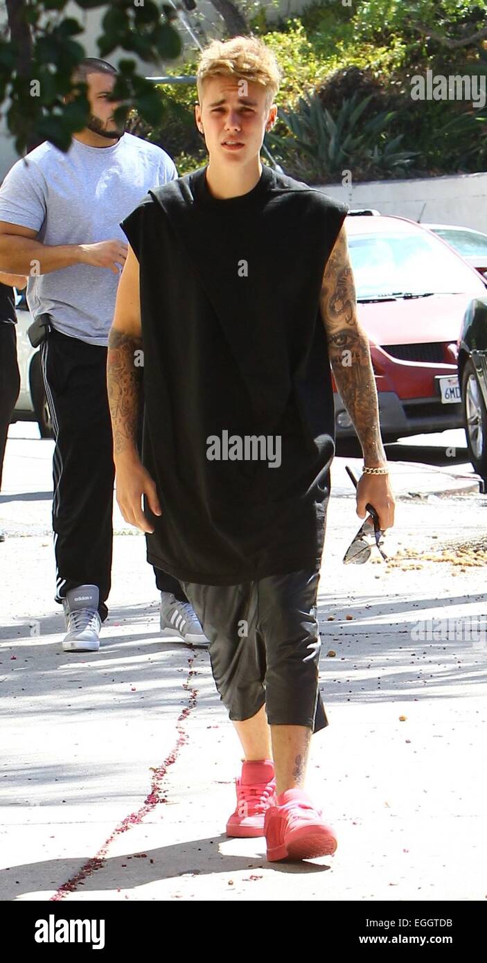 Justin Bieber arrives at Sushi Dan in Studio City in his Ferrari 458  Italia, wearing pink suede Adidas sneakers. He left in a 2014 Cadillac  Escalade driven by his bodyguards. Featuring: Justin