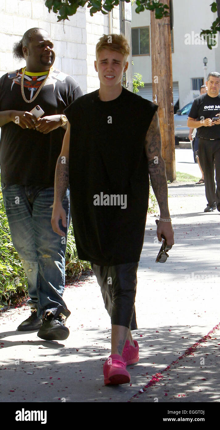 Justin Bieber arrives at Sushi Dan in Studio City in his Ferrari 458  Italia, wearing pink suede Adidas sneakers. He left in a 2014 Cadillac  Escalade driven by his bodyguards. Featuring: Justin