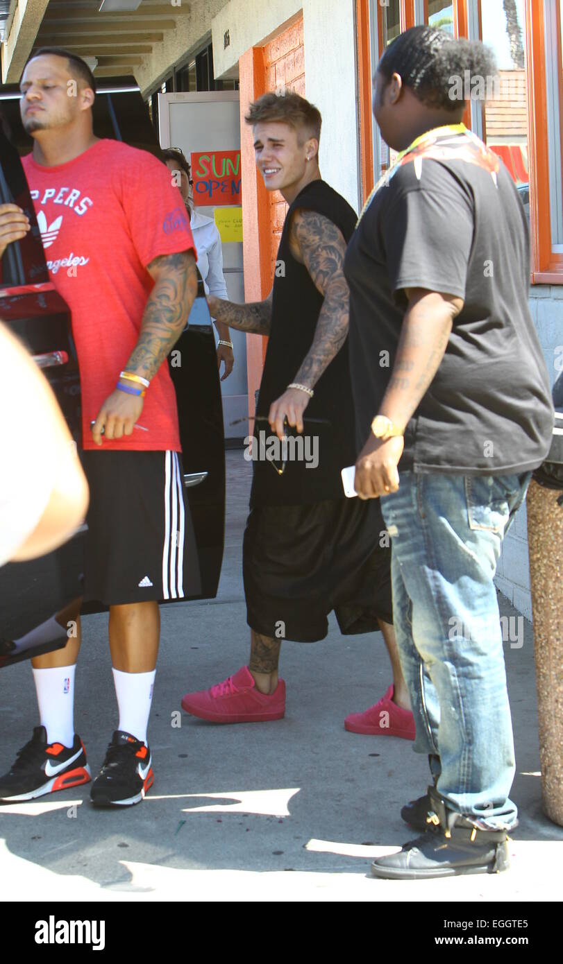 Justin Bieber arrives at Sushi Dan in Studio City in his Ferrari 458  Italia, wearing pink suede Adidas sneakers. He left in a 2014 Cadillac  Escalade driven by his bodyguards. Featuring: Justin