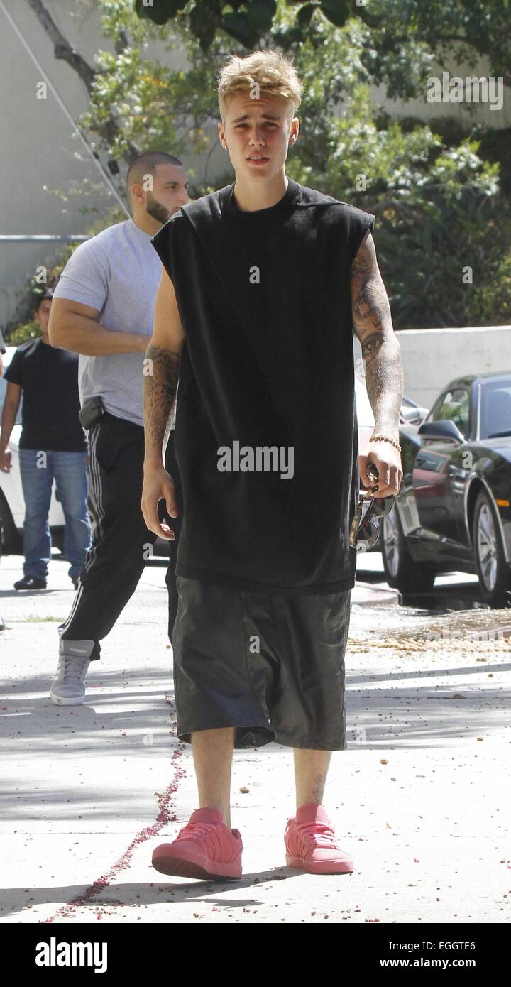 Justin Bieber arrives at Sushi Dan in Studio City in his Ferrari 458  Italia, wearing pink suede Adidas sneakers. He left in a 2014 Cadillac  Escalade driven by his bodyguards. Featuring: Justin