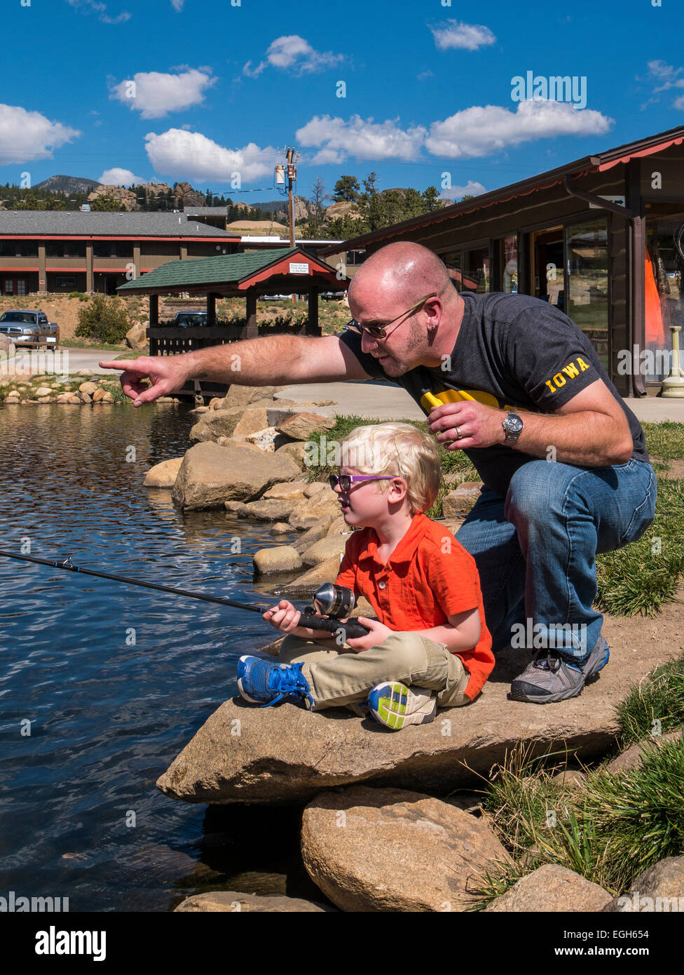 Father and son fish the pond at Trout Haven, Estes Park, Colorado Stock