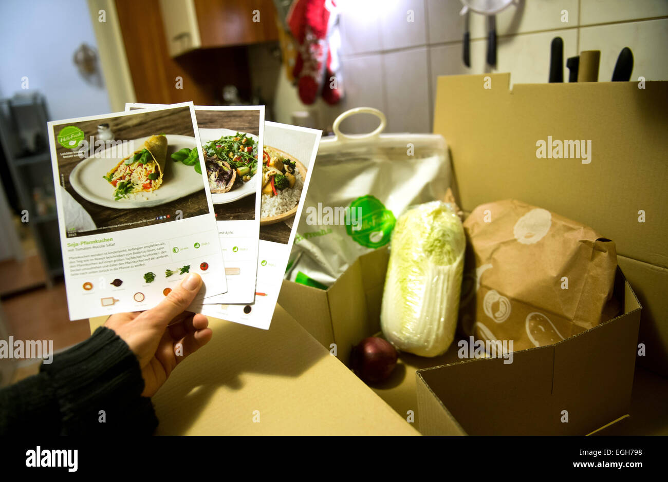 Stuttgart, Germany. 16th Feb, 2015. ILLUSTRATION - A man holds up delivered cooking recipe from a HelloFresh cooking box in Stuttgart, Germany, 16 February 2015. Photo: Daniel Naupold/dpa/Alamy Live News Stock Photo