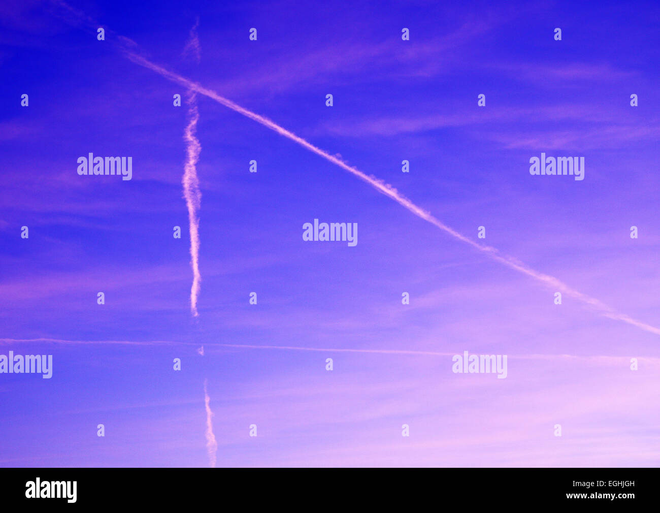 few airplane traces on colored sky Stock Photo