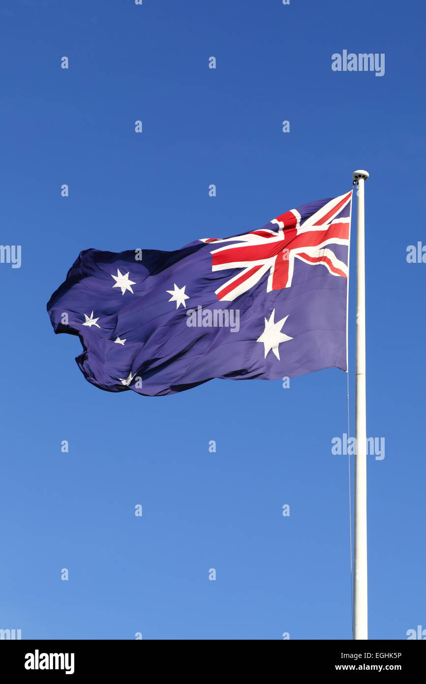 The Australian Flag flying proudly from the Bicentennial Flagpole on Cockle Bay - Darling Harbour, Sydney, NSW, Australia. Stock Photo