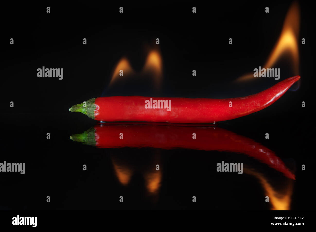 Hot chili pepper, with flames Stock Photo