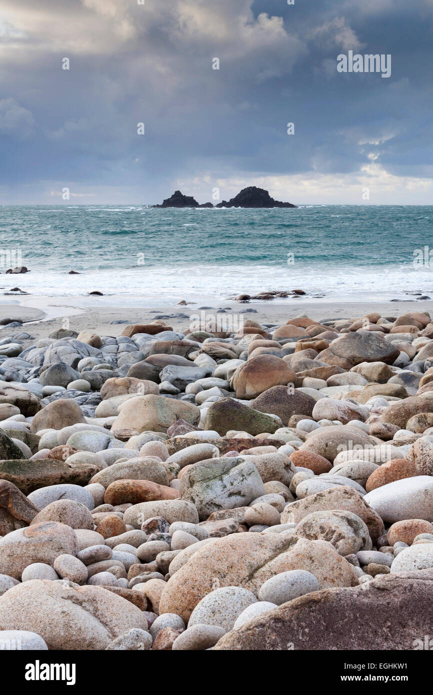 Stones on rocky beach with sea view to the Brisons, 'Porth Nanven', 'Cot Valley', Cornwall, England, UK Stock Photo