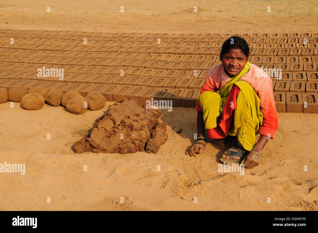 Indian woman making clay hand made mud bricks  Madhya Pradesh India Stock Photo