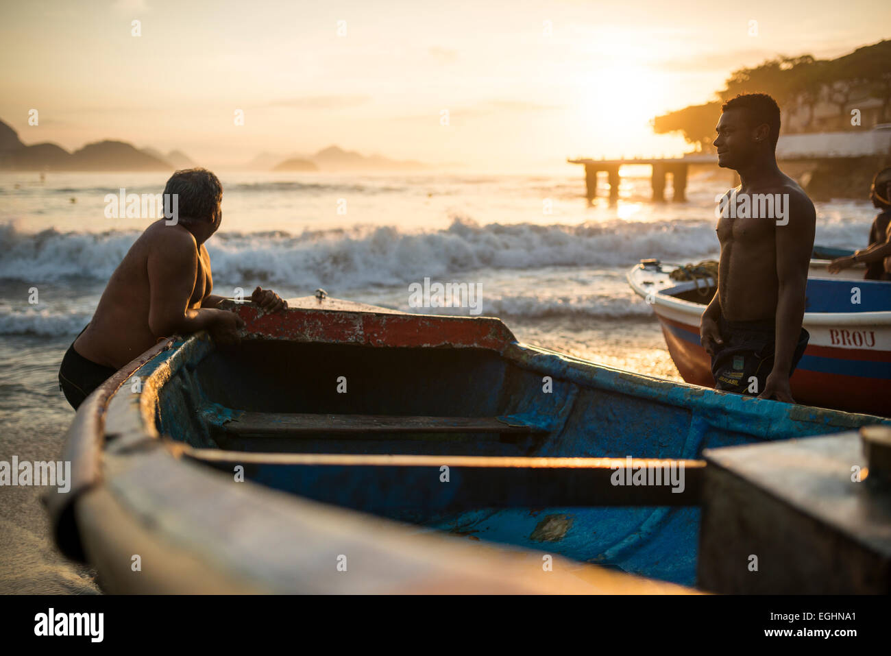 Fishermen taking their boats out at dawn, Copacabana Beach, Rio de Janeiro, Brazil Stock Photo