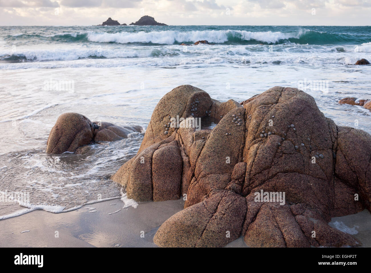 Beach boulders and sea view to the Brisons rocks, 'Porth Nanven', 'Cot Valley', Cornwall, England, UK Stock Photo