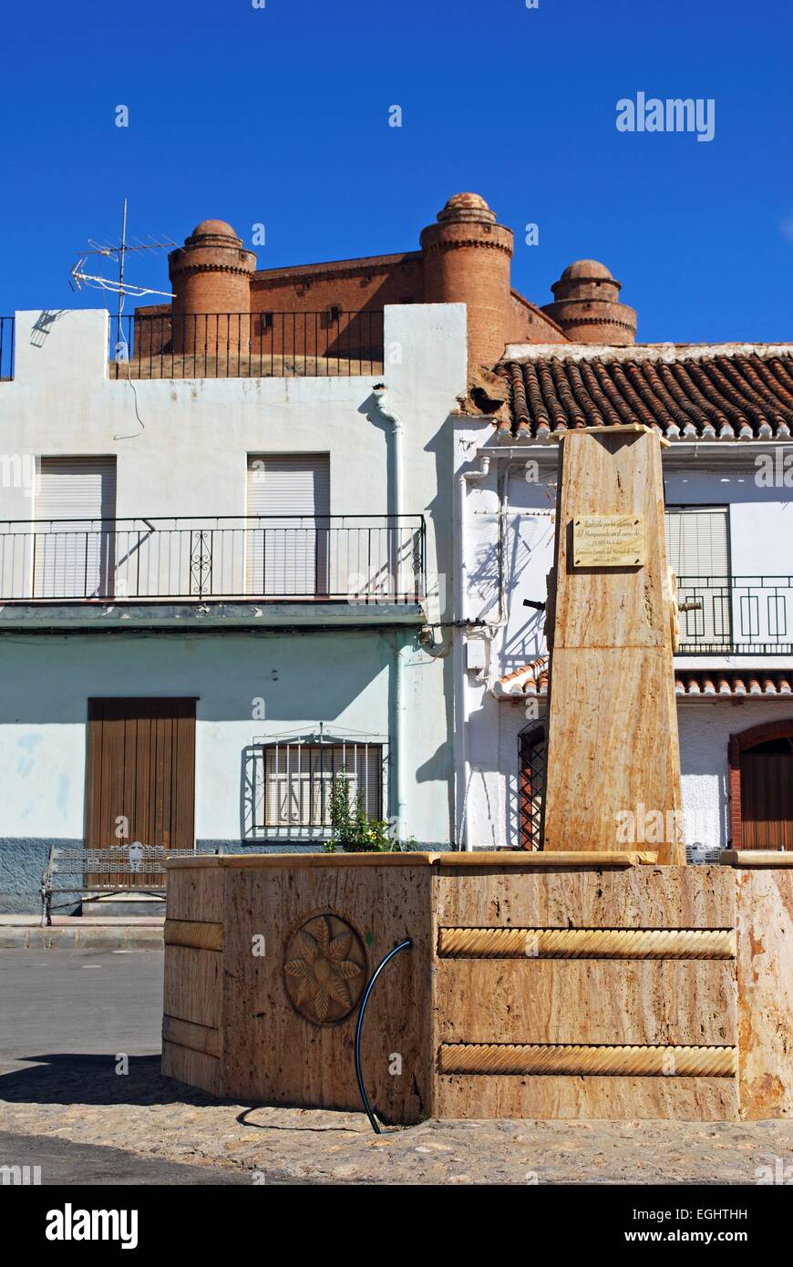 Fountain in town centre with view towards the castle (Castillo de La Calahorra), La Calahorra, Granada Province, Spain. Stock Photo