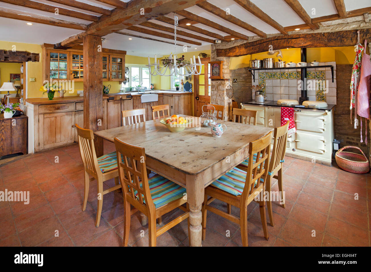 Traditional Farmhouse Kitchen with pine dining table and Aga range in English farmhouse Stock Photo