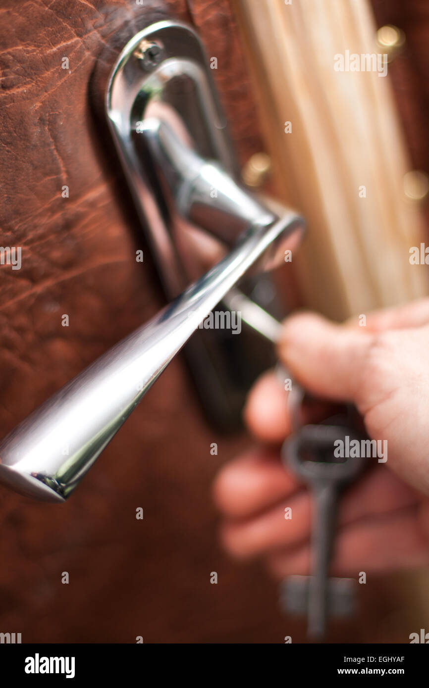 doorhandle close up with hand opening door with a key Stock Photo - Alamy