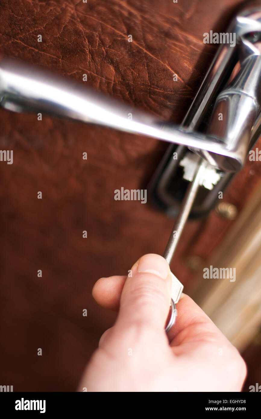 doorhandle close up with hand opening door with a key Stock Photo - Alamy