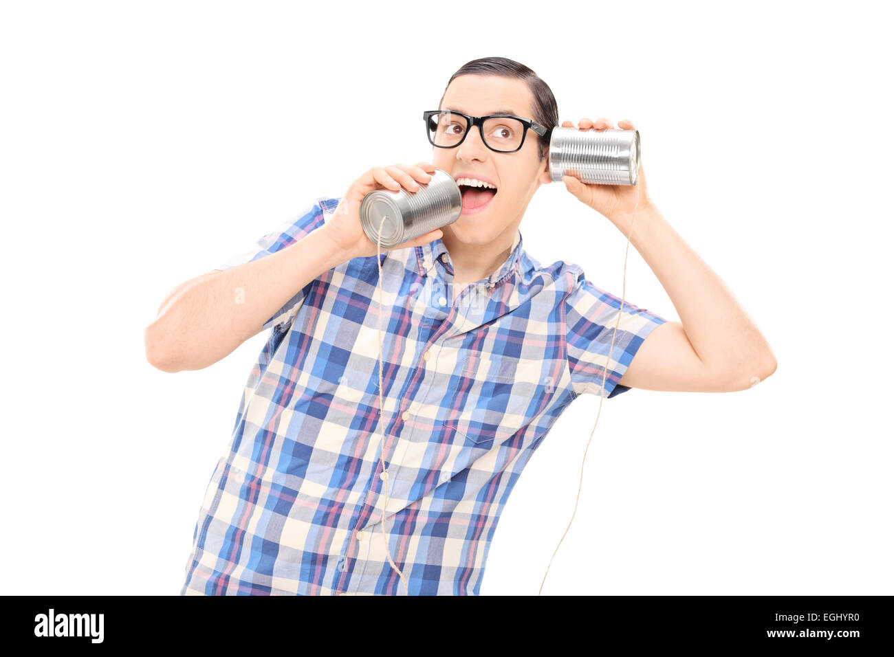 Silly man talking to himself through tin can phone isolated on white background Stock Photo