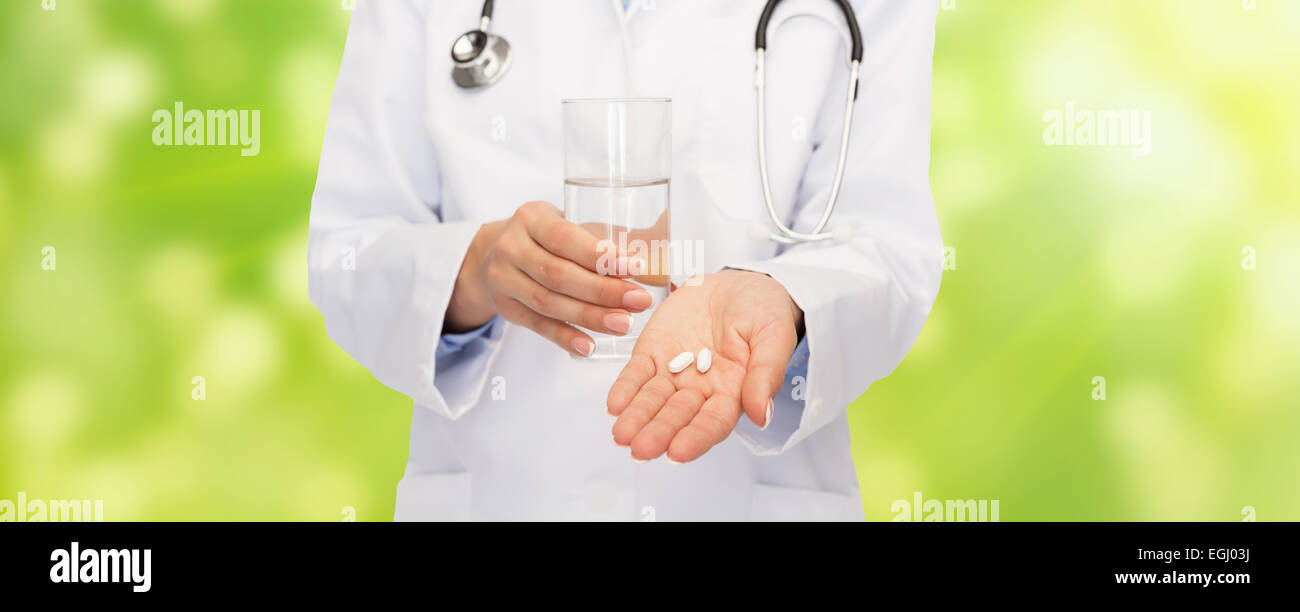 close up of doctor offering pills and water Stock Photo