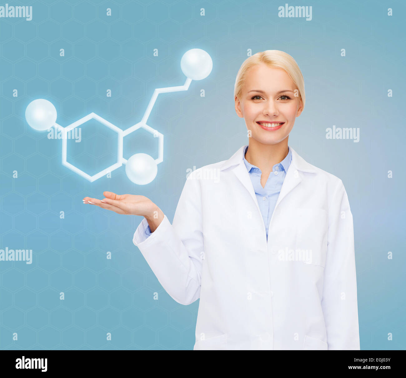 smiling female doctor pointing to molecule Stock Photo