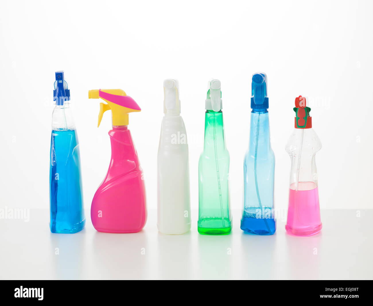 group of colored cleaning spray bottles on table with white background Stock Photo