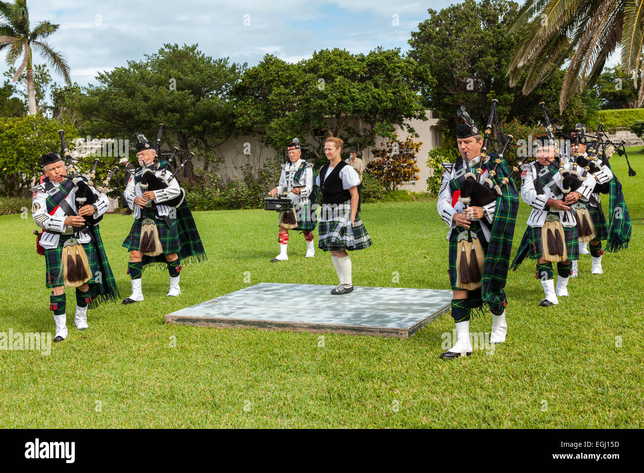 Kilted members of the Bermuda Islands Pipe Band as well as a highland dancer at Fort Hamilton in Hamilton, Bermuda. Stock Photo