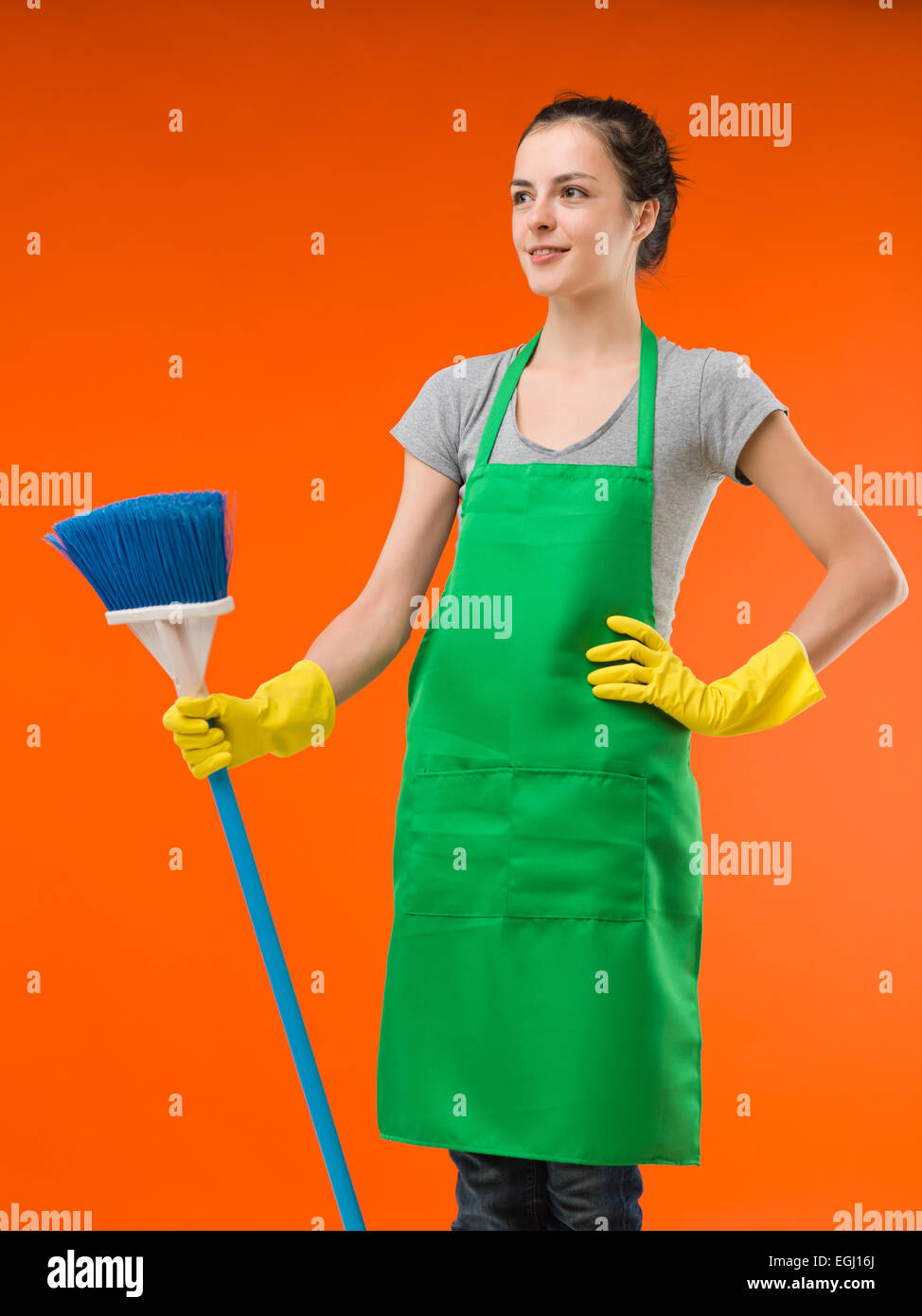 https://c8.alamy.com/comp/EGJ16J/happy-cleaning-lady-standing-and-holding-broom-on-orange-background-EGJ16J.jpg
