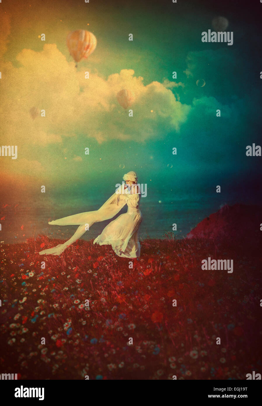 young woman in white dress dancing on the cliff Stock Photo