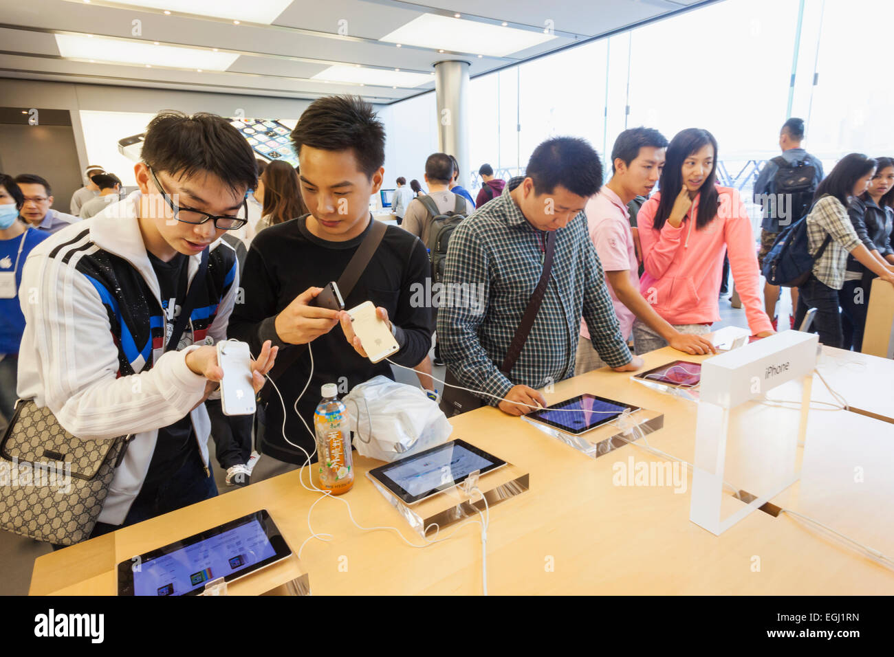 A Salesperson and Customers at an Apple Store Looking at the Latest Apple  IPhone 12 Models for Sale Editorial Stock Photo - Image of consumerism,  design: 203627358