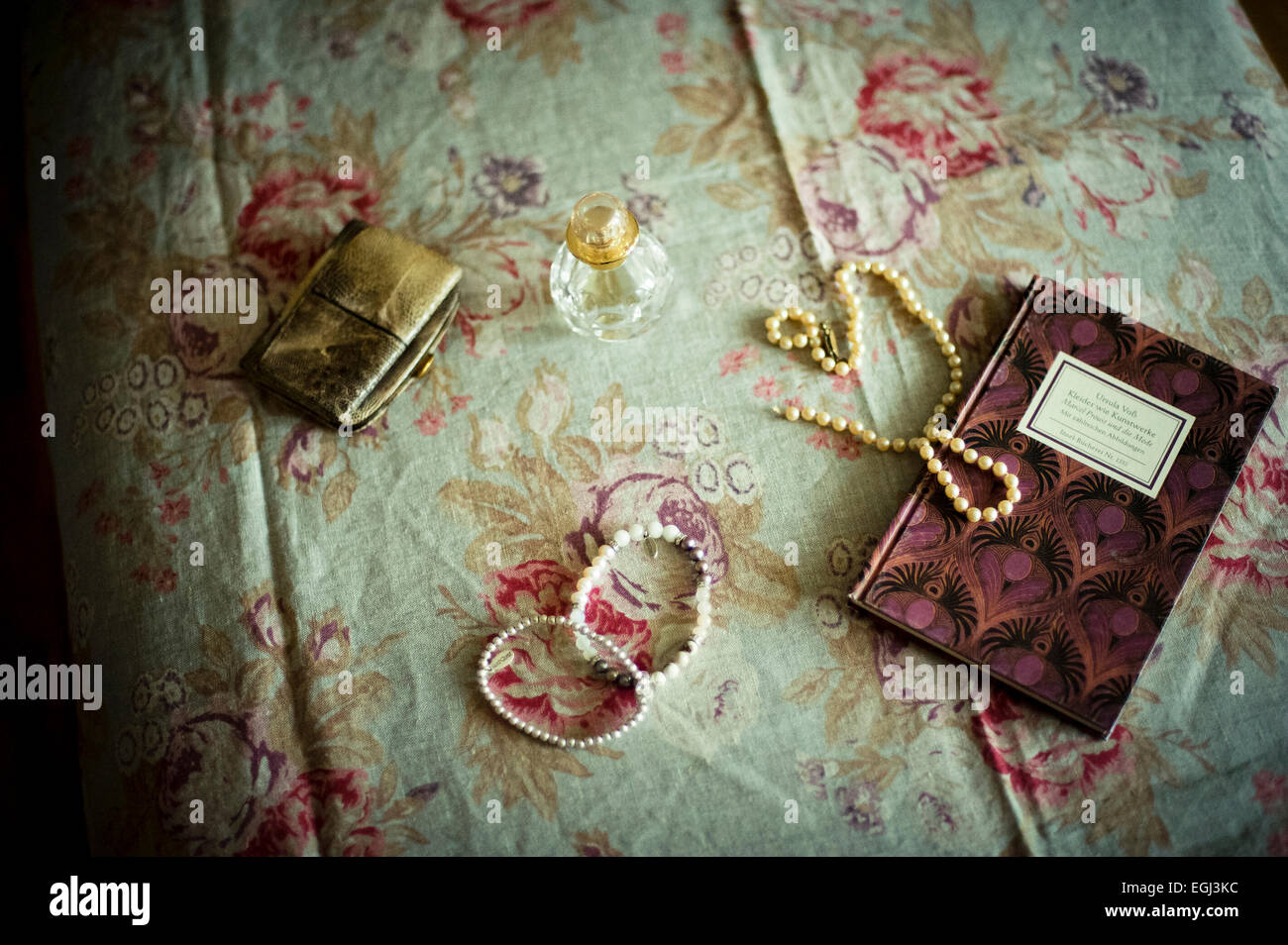Still life with Flacon, pearl necklace and book, Stock Photo