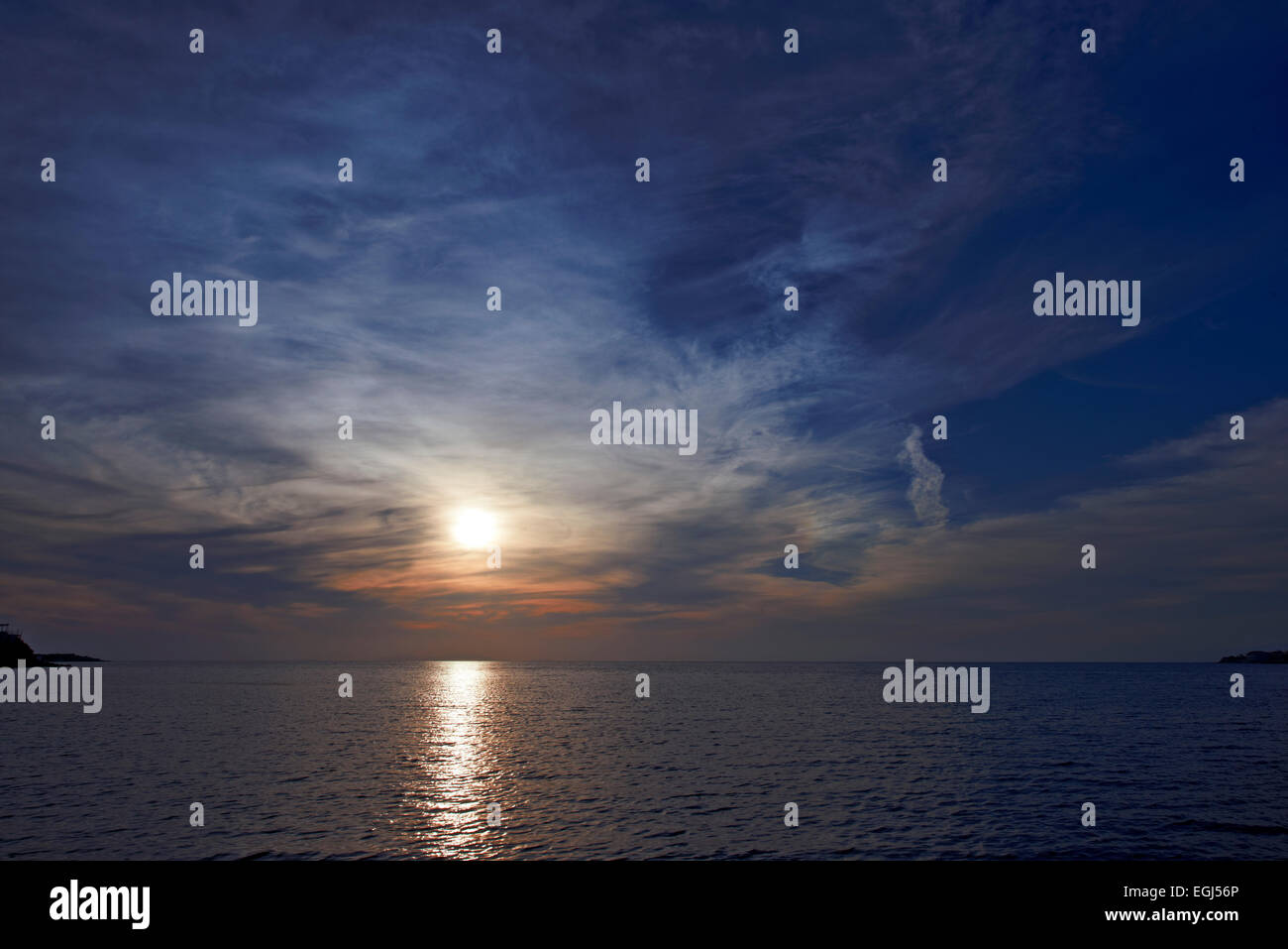 Sunset over water Stock Photo - Alamy