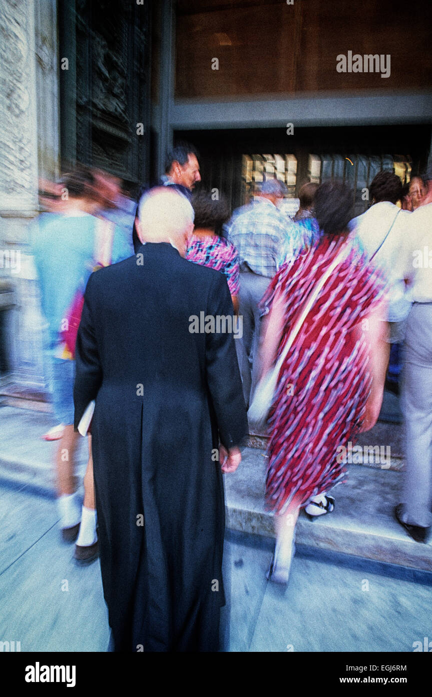 Priest entering church in Siena, Tuscany Stock Photo