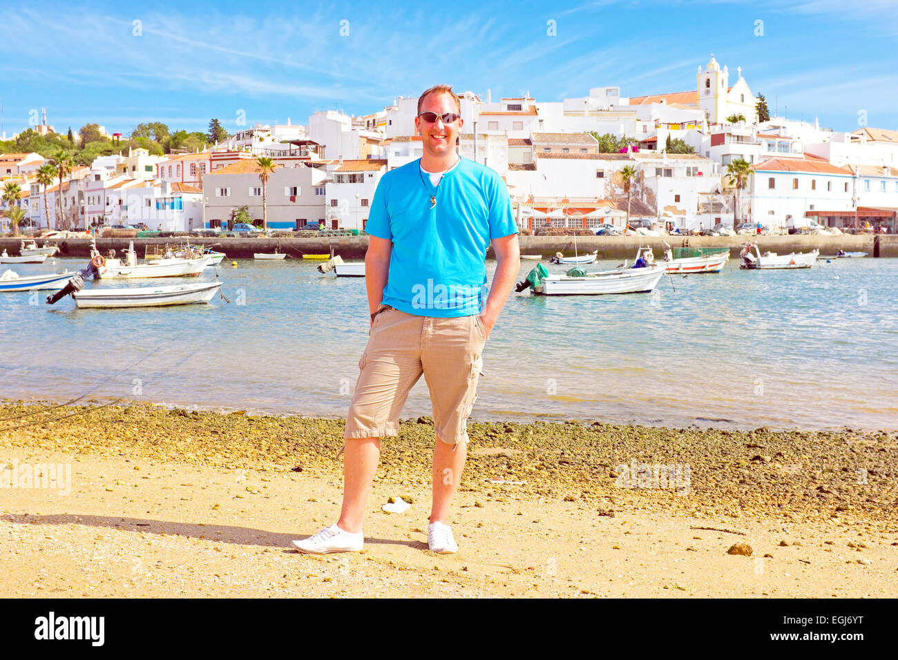 Tourist at the beach near Ferragudo Portugal Stock Photo