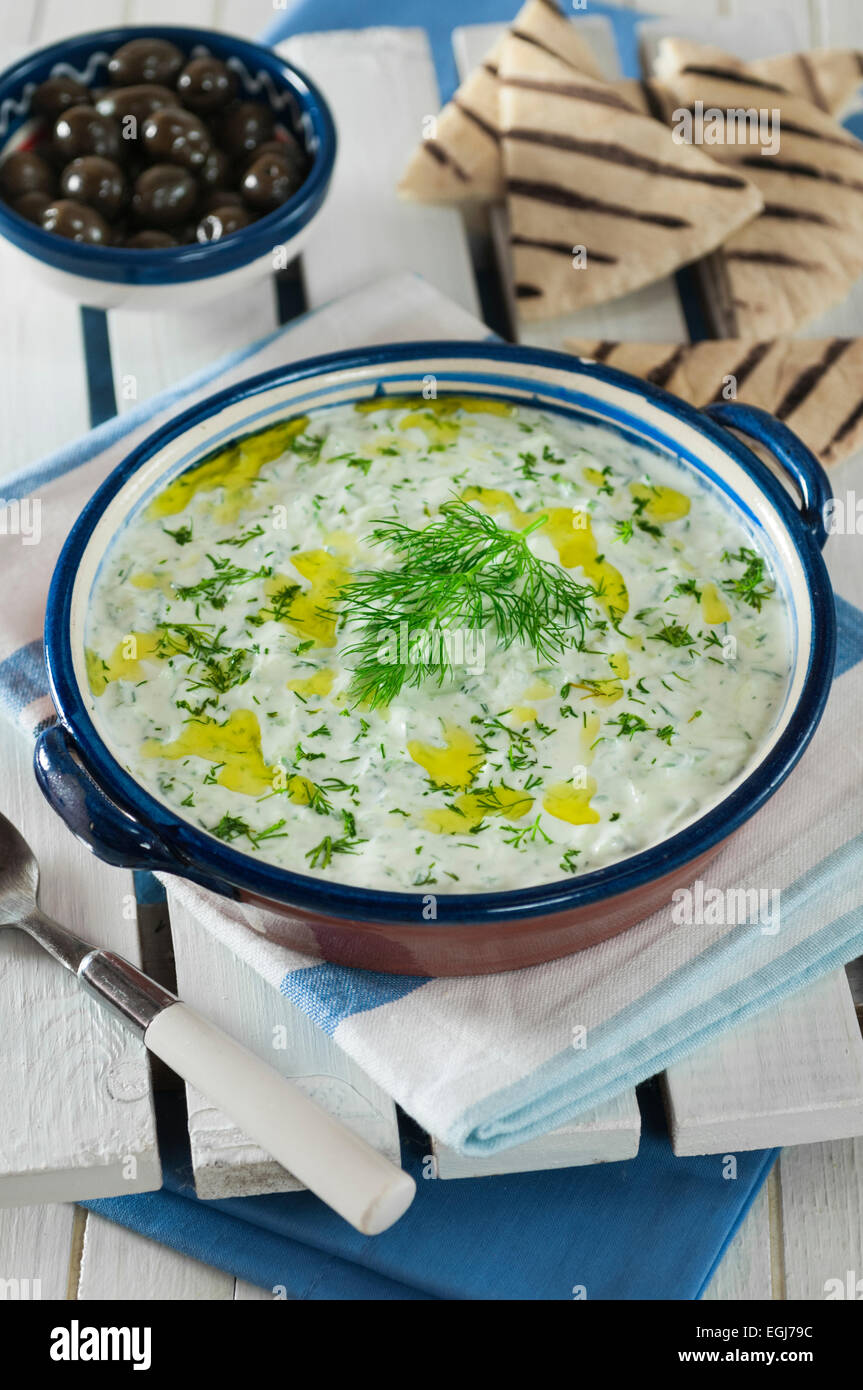 Tzatziki. Yogurt and cucumber relish with pitta bread. Stock Photo