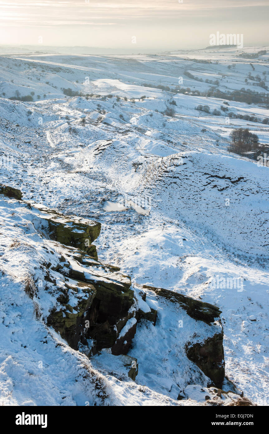 Soft afternoon light on a snowy landscape below Coombes edge above the village of Charlesworth, Derbyshire. Stock Photo