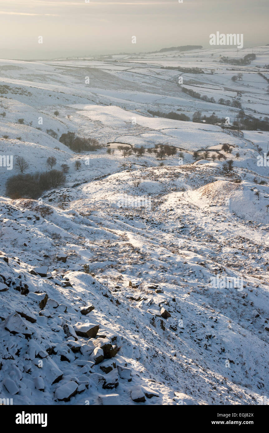 Soft afternoon sunlight on a snowy landscape below Coombes edge in Charlesworth, Derbyshire. Stock Photo
